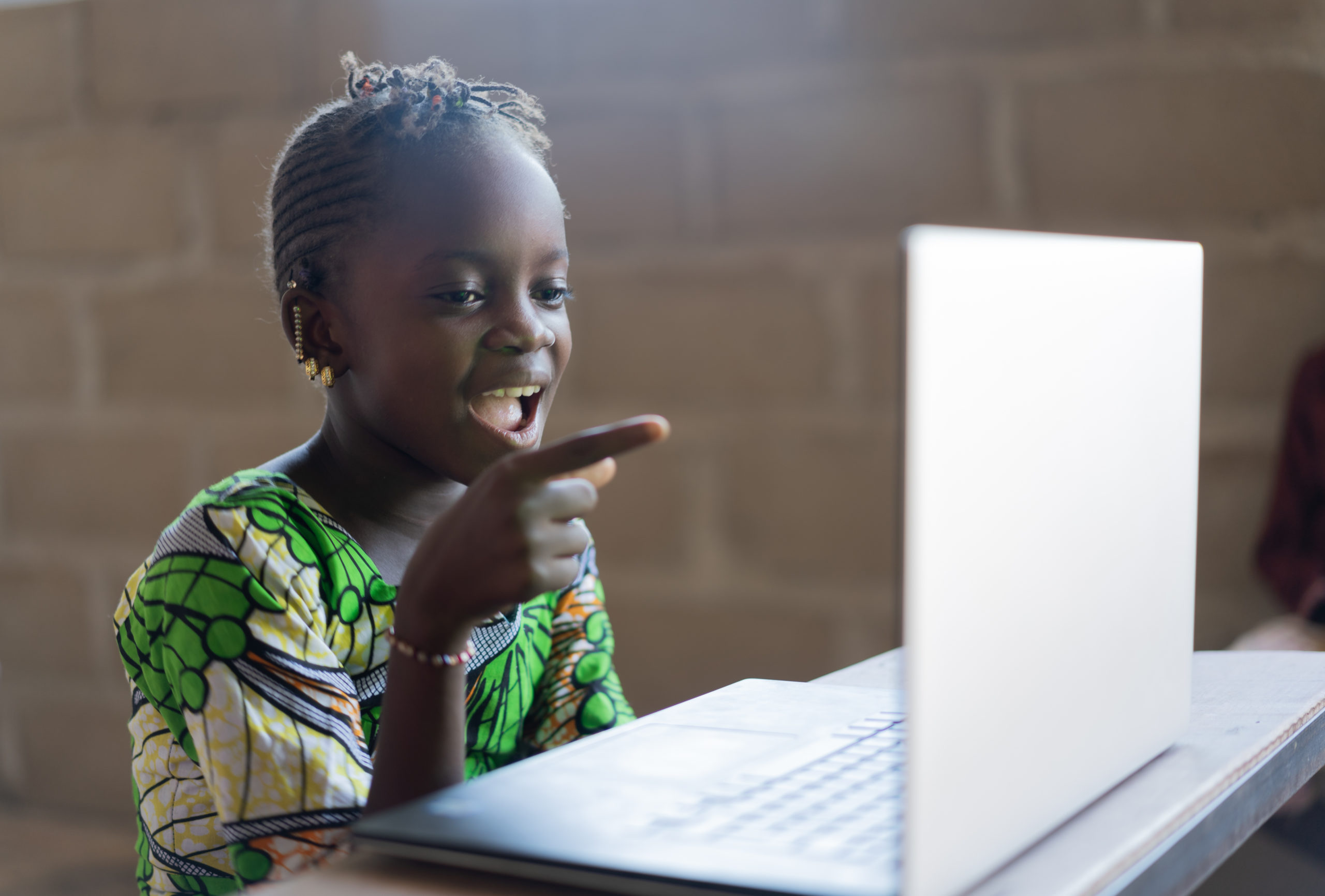 Adorable,African,Little,Girl,Surprised,Looking,At,Laptop,Computer,Technology